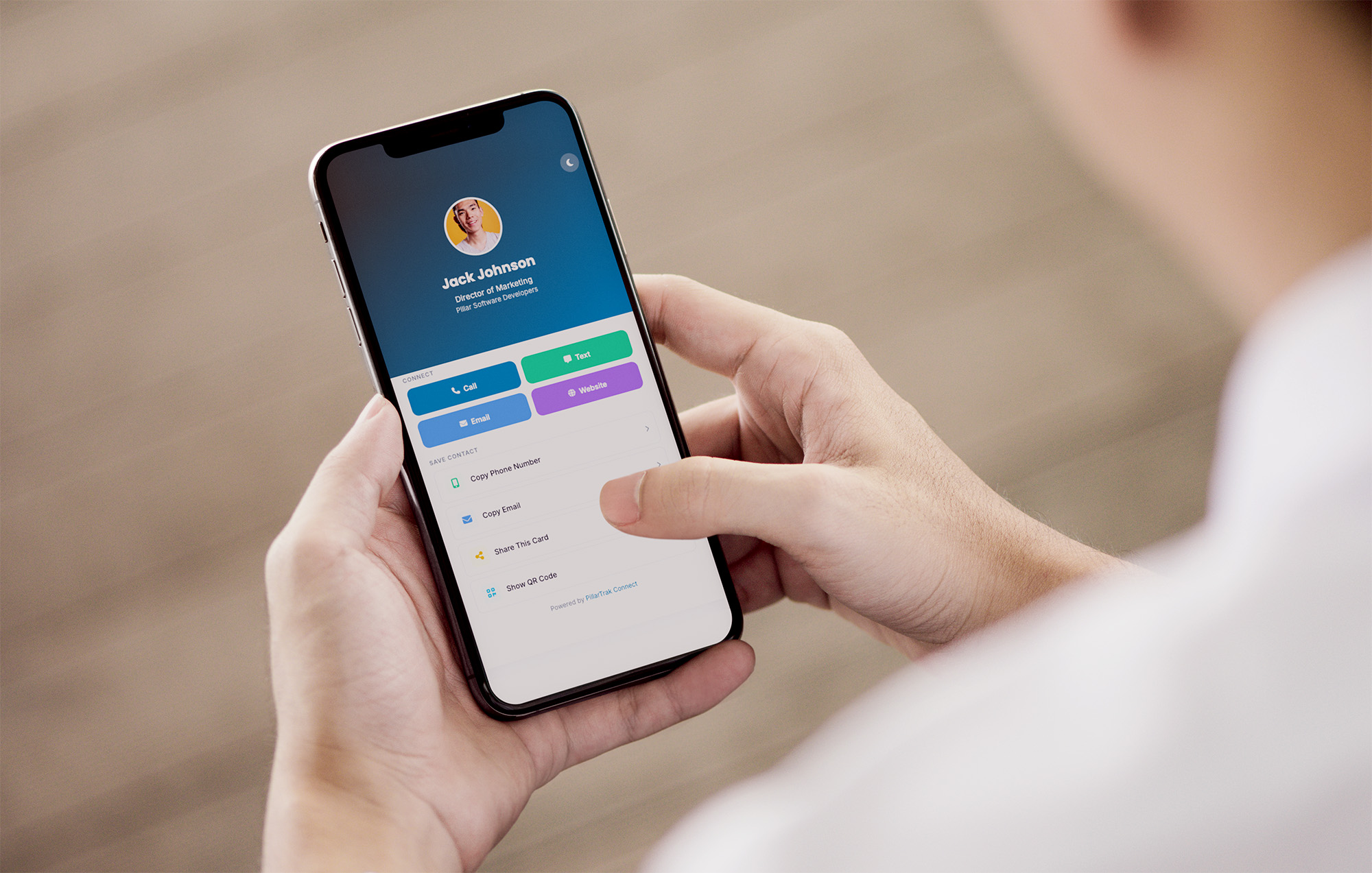 Person viewing a PillarTrak CONNECT digital contact profile on a smartphone.